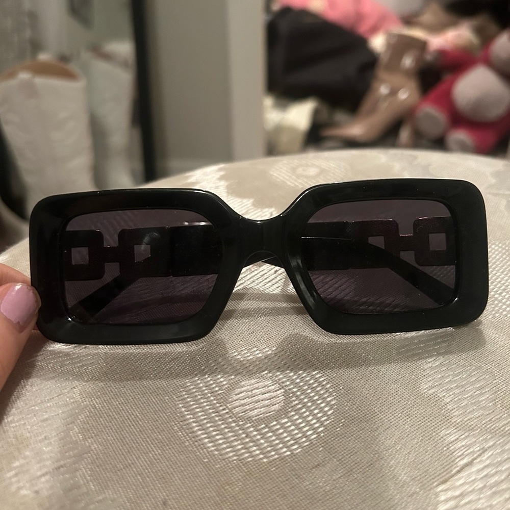 Black thick sunglasses with gold embellishments